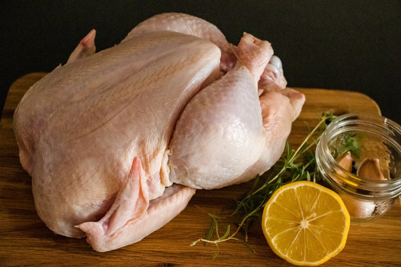 A whole fresh chicken prepared for cooking