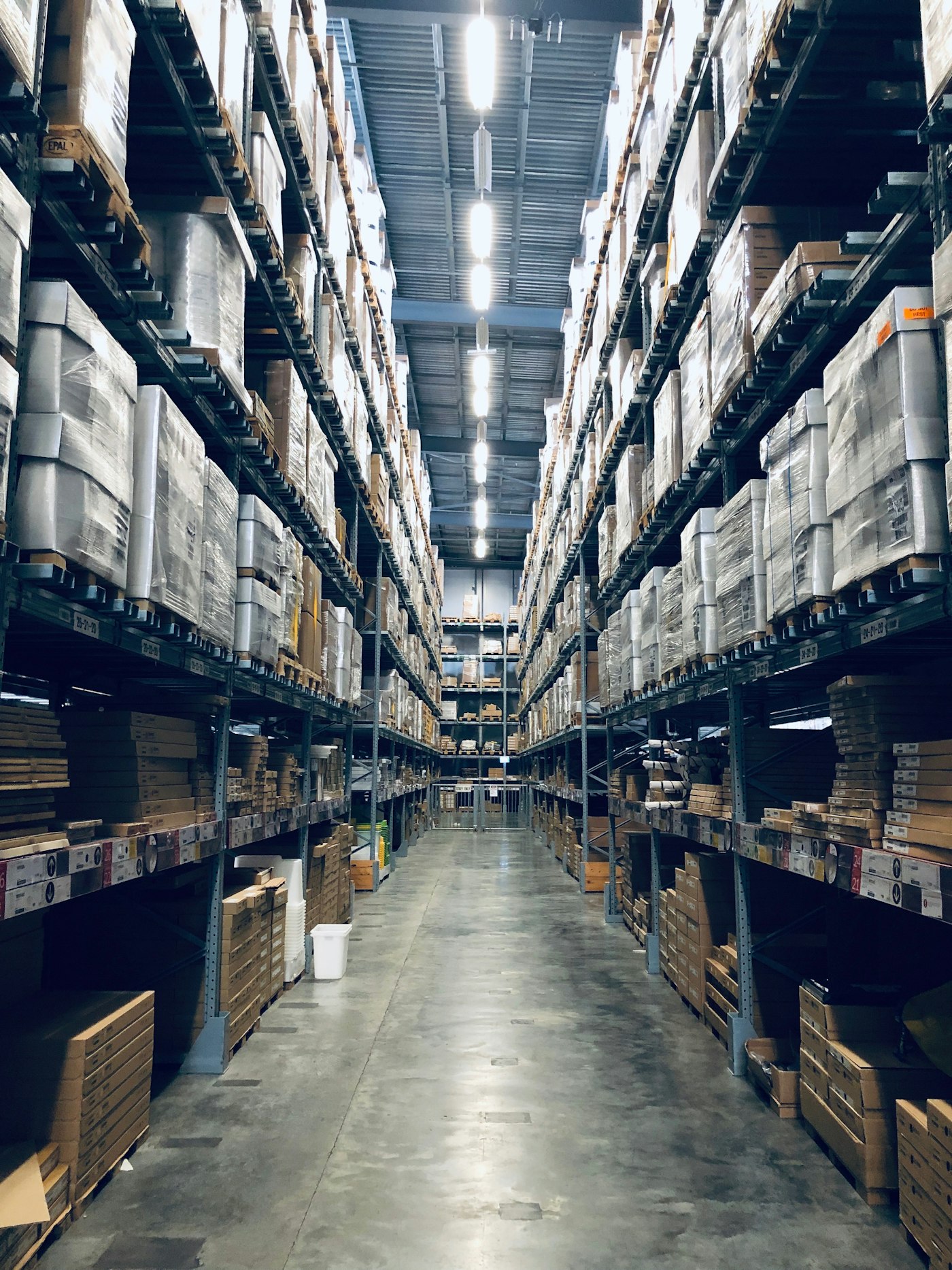 A clean distribution warehouse aisle stocked for fulfilment